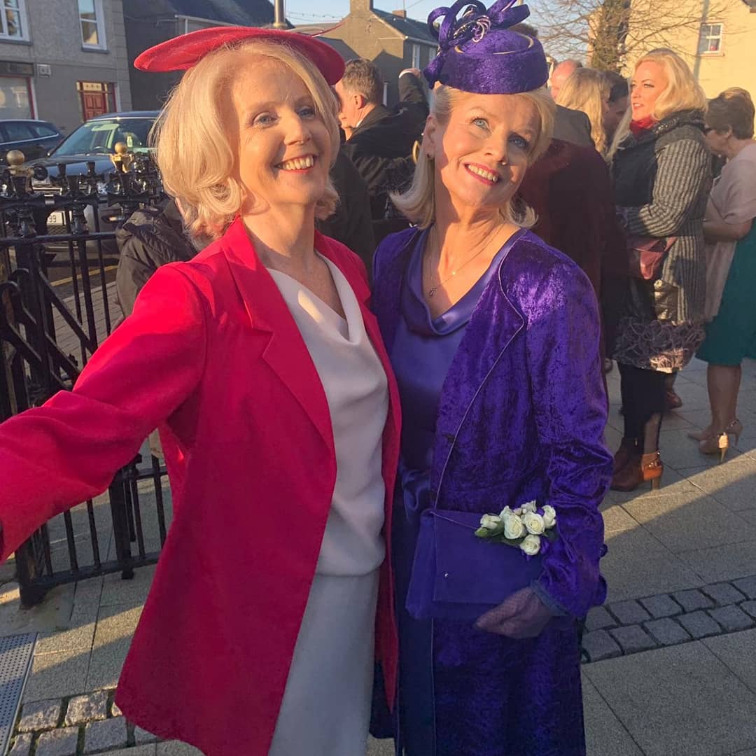 two women in dresses